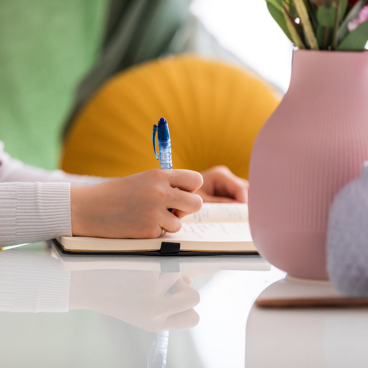 Lady writing in her support worker diary