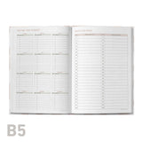 Open planner with detailed schedules on a white background
